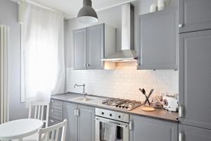 a kitchen with white cabinets and a stove top oven at Riviera Marco Polo in Mestre