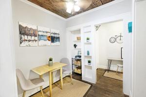 a dining room with a table and chairs and a desk at Global Cup Urban Convenience Studio Flat in Dallas