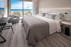 a bedroom with a large bed and a view of the ocean at Bel Air in Castelldefels