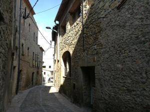 an alley in an old town with stone buildings at El Paller de Can Puig a la Pera 4/6 pax in La Pera