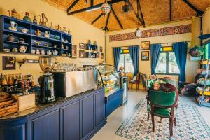 a kitchen with blue cabinets and a counter top at La Reina Maroc Hotel ปากช่อง เขาใหญ่ in Pak Chong