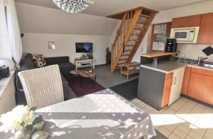 a kitchen and a living room with a table and a couch at Apartments mit Flair in Fehmarn
