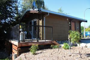 a cabin with a porch and a balcony at Sunset Chalet in Lake Tekapo