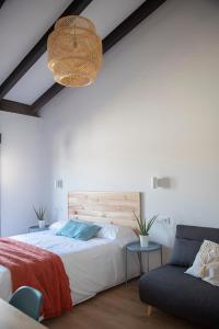 a bedroom with a large bed and a couch at Alojamiento rural La Moravieta in Pozoamargo +33 photos