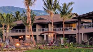 a resort with palm trees in front of a building at Honua kai - Luana Garden Villa 3C in Kaanapali