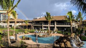 a resort with a swimming pool with a waterfall at Honua kai - Luana Garden Villa 3C in Kaanapali