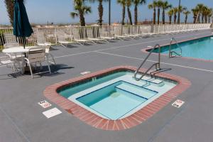 a swimming pool at a resort with a tennis court at Regency Isle 411 in Orange Beach +41 photos
