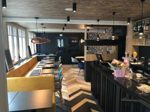 a bar in a restaurant with tables and chairs at Les Chiens du Guet in Saint Malo