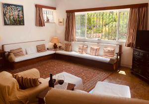 a living room with two couches and a window at Charming Villa with Heated Pool near Sandy Beach, Hiking, Golf and Wineries in Luz