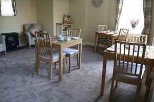 a dining room with a table and four chairs at Dent Stores B&B in Dent