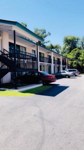 un bâtiment avec des voitures garées dans un parking dans l'établissement Relax Inn Savannah, à Savannah