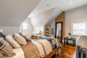 a bedroom with a bed with pillows at NB Urban Luxury Suites in Toronto