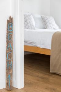 A bed or beds in a room at The Beach Huts 