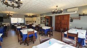 a dining room with tables and chairs in a restaurant at Hotel Prados in Lugo