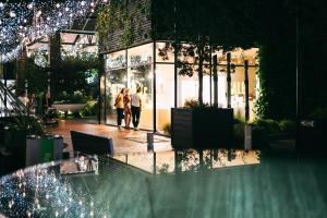 two people standing in front of a building with christmas lights at The Hotel Britomart in Auckland