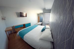 Llit o llits en una habitació de HOTEL AZUL AGAVE