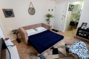 a bedroom with a bed with a blue blanket at APÊ 5 ESTRELAS CENTRAL-FREE VAGA&NETFLIX in Ribeirão Preto