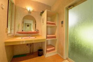 a bathroom with a sink and a mirror at Blue Marble in Ito