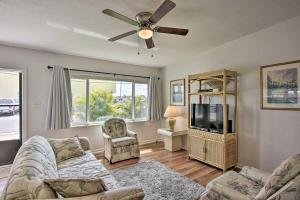 a living room with a couch and a tv at Sunny Cocoa Beach Home Walk to Sea and Attractions! in Cocoa Beach