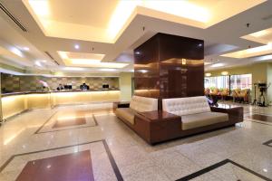 a lobby with a couch and a bar at Hotel Grand Continental Kuala Lumpur in Kuala Lumpur