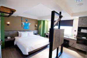 Postel nebo postele na pokoji v ubytování Huwei Hotel