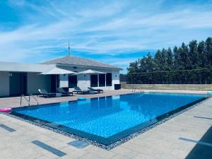 a large swimming pool in front of a house at The Residency Towers, Rameswaram in Rāmeswaram