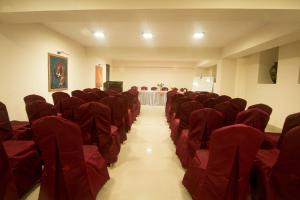 an empty room with red chairs and a table at Central Hill Resort The Mall Road in Gangtok
