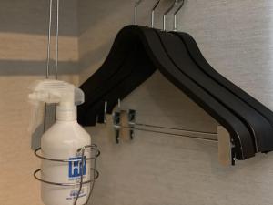 a bottle of cleaning agent next to a black railing at Hotel Trusty Osaka Abeno in Osaka