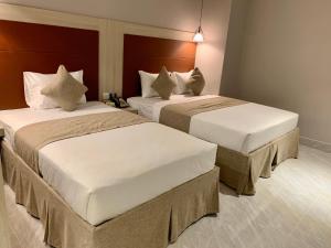 Giường trong phòng chung tại HOLIDAY 2 HOTEL