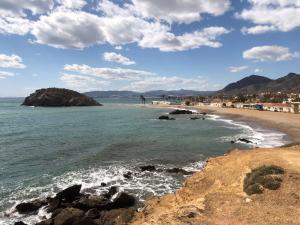 a view of the beach from the rocks at Our Sol in Puerto de Mazarrón