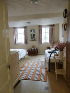 a bedroom with two beds and a rug at Chateau View Chambres d'hôtes in Quillan