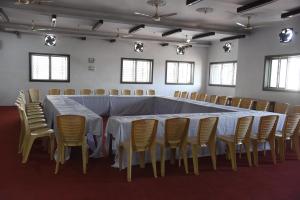 a long table and chairs in a room at Natraj Hotel in Darbhanga
