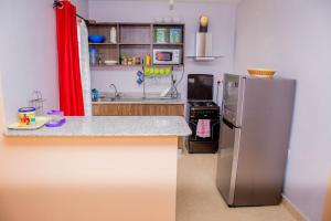 a kitchen with a stainless steel refrigerator and a stove at Beautiful and Homely in Eldoret