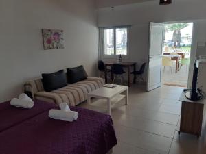 a living room with two beds and a couch at ZORBAS Sea View No 5 in Larnaca