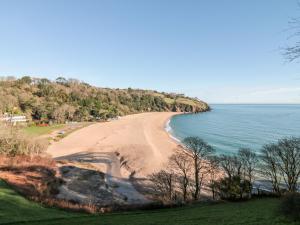 a view of a beach next to the water at Yew Tree Cottage in Dartmouth