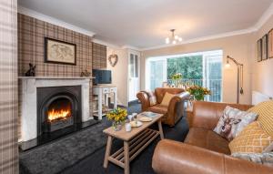 a living room with a couch and a fireplace at Esk View Cottage in Grosmont