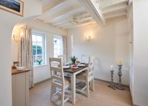 a kitchen and dining room with a table and chairs at Rigg Cottage in Whitby