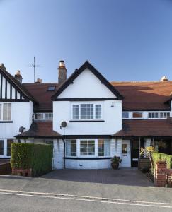 a white house with a lot of windows at Rigg Cottage in Whitby