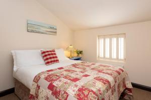 a bedroom with a large bed and a window at Rose Cottage, Filey in Filey