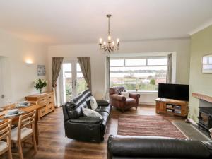 a living room with a couch and a table at 8 Mere View Avenue in Hornsea