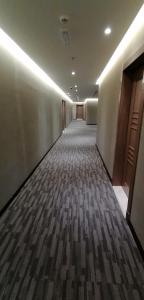 an empty hallway in a building with ailed floor at Manazel Al Diafa Serviced Apartments in Riyadh