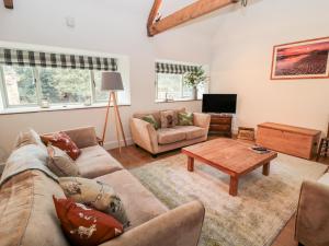 a living room with a couch and a coffee table at The Old Workshop in Belford