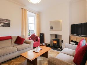 a living room with a couch and a fire place at Beach House in Bridlington