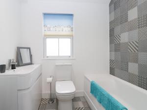 a white bathroom with a toilet and a sink at Beach House in Bridlington +26 photos
