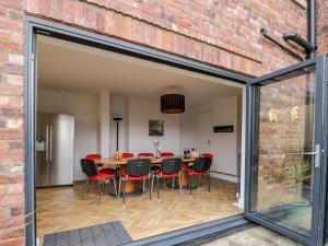 a dining room with sliding glass doors and a table and chairs at Beach House in Bridlington