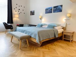 a bedroom with a large bed with blue pillows at Marienbad Apartment in Mariánské Lázně
