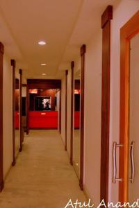 an empty hallway in a building with a red wall at Natraj Hotel in Darbhanga