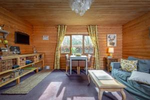 a living room with a couch and a table at Redlands Country Lodge in Ladybank