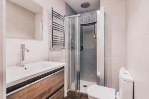 a bathroom with a sink and a shower at Plaza Nueva apartment by People Rentals in Bilbao +31 photos
