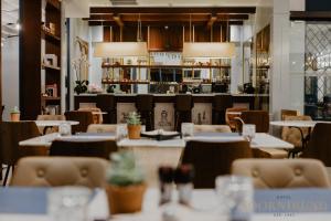 a dining room with tables and chairs and a restaurant at SOOKNIRUND HOTEL in Chiang Rai